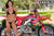 July's Risk Racing Moto Model Samantha Heady posing in various bikinis & Risk Racing Jerseys next to Alex Ray's Honda CR250R that's sidding on a Risk Racing ATS stand - Pose #15