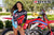 July's Risk Racing Moto Model Samantha Heady posing in various bikinis & Risk Racing Jerseys next to Alex Ray's Honda CR250R that's sidding on a Risk Racing ATS stand - Pose #16