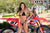 July's Risk Racing Moto Model Samantha Heady posing in various bikinis & Risk Racing Jerseys next to Alex Ray's Honda CR250R that's sidding on a Risk Racing ATS stand - Pose #30