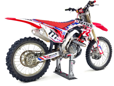 Full size dirt bike secured into a Lock-n-load pro dirt bike transport system on white studio background