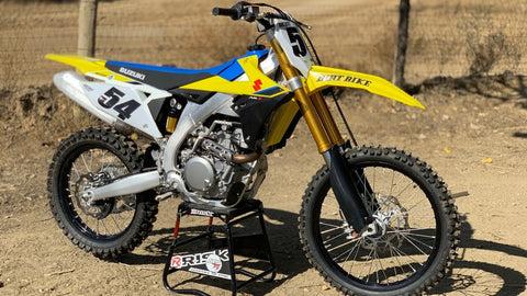 2022 suzuki motocross bike sitting on a risk racing a.t.s. stand