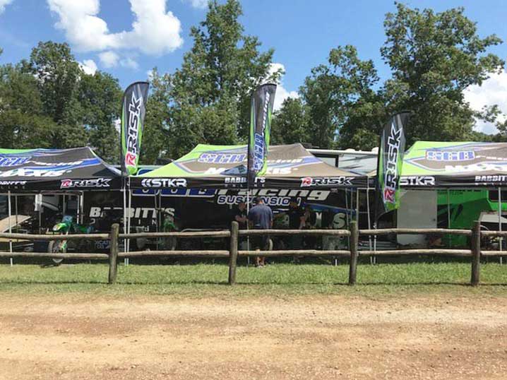 Fila de pozos de motocross con toldos de pits de carreras de riesgo y STKR