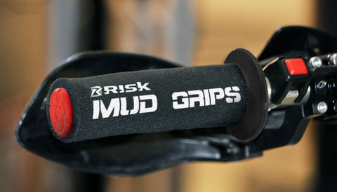 TISK Racing mud grips slid over the left grip of a dirt bike. The mud grip is designed to allow the rider to maintain grip even if the the bike or rider fall in the mud.