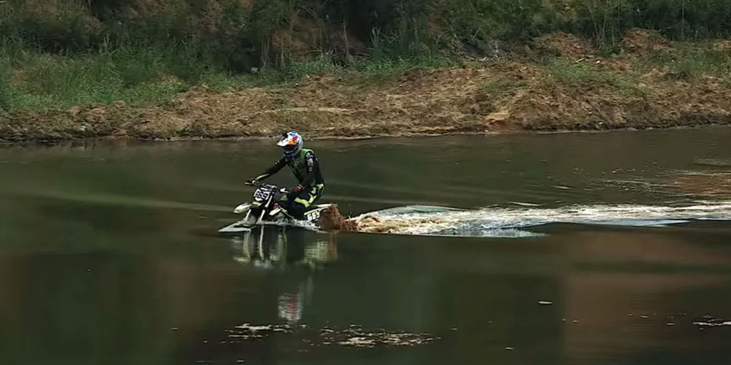 mx number 669 submerging a dirt bike in the middle of a large body of water