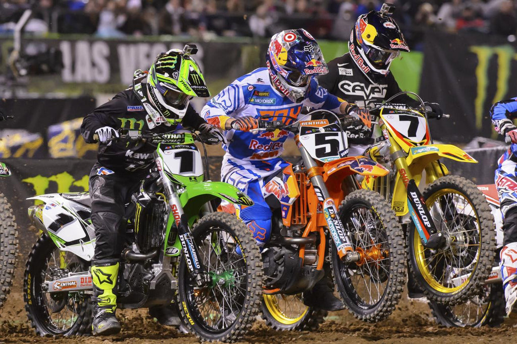 mx numbers 1 5 7 all exploding off the starting line at an indoor race