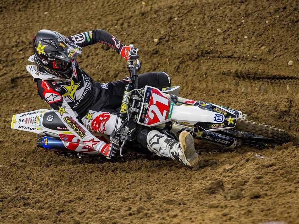 motocross number 21 leaning into a turn extremely hard almost completely horizontal