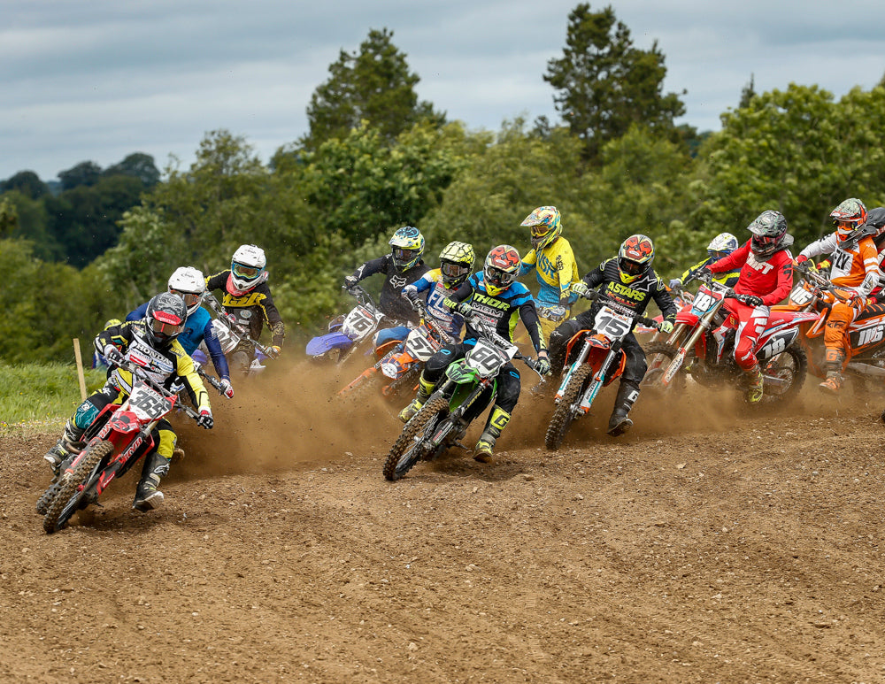 pack of mx riders 365-76-57-60-15-18 twelve plus all turning together on an outdoor track