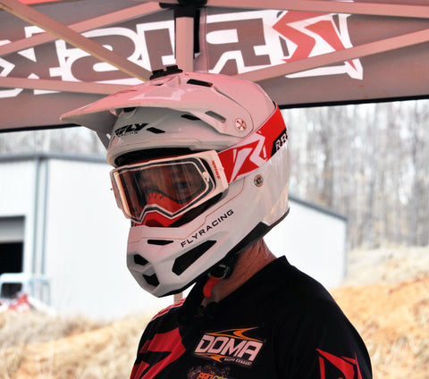 Sponsored motocross rider displaying their supporters on their jersey