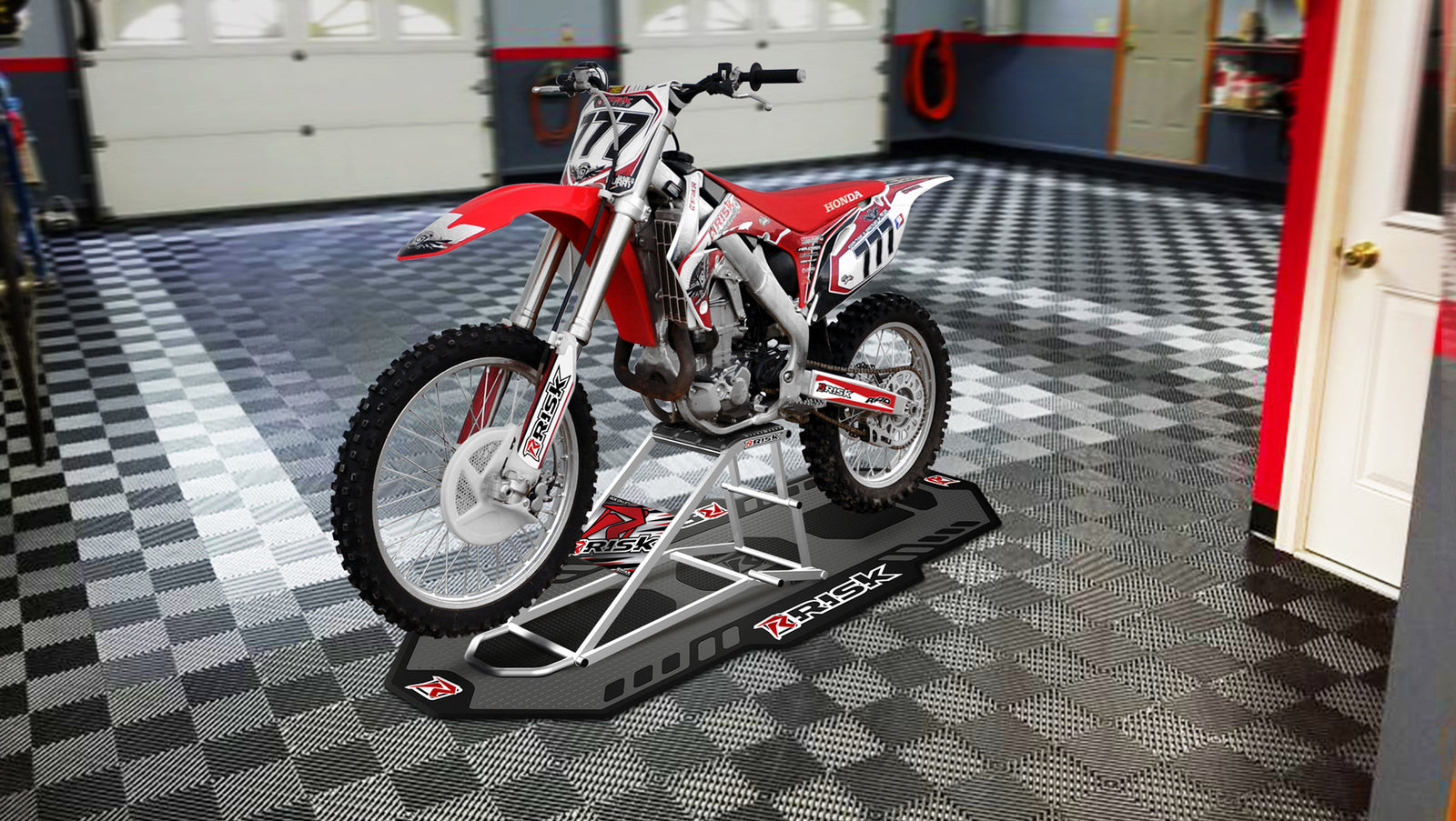 RR1 Ride-On Lift Stand in the garage with a red honda dirt bike sitting on it