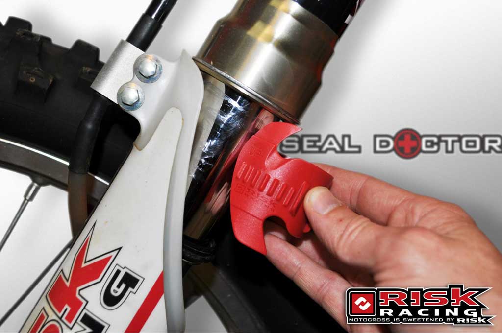 seal doctor in action going onto dirt bike forks with logo and branding