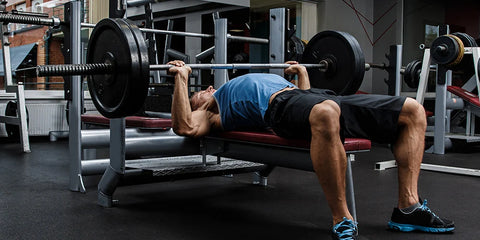 Someone performing the bench press exercise. 