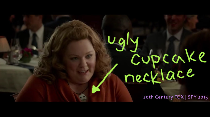 Melissa McCarthy wearing ugly cupcake necklace