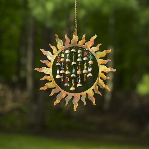 A colorful wind chime featuring enamel bells and a sunburst. 