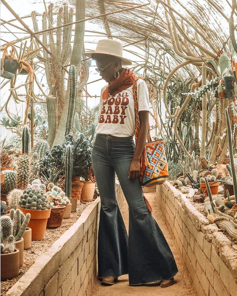 Black women wearing scarf and colorful handbag