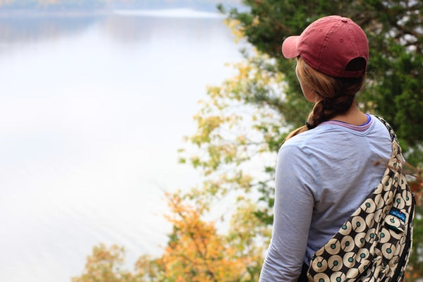 a hiker wearing a hat to avoid dehydration while hiking in the sun