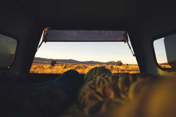sleeping in car while car camping outdoors