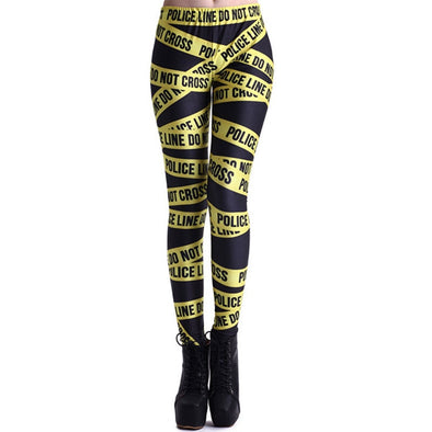 Model wearing black leggings with "Police Line do not cross" tape printed on it