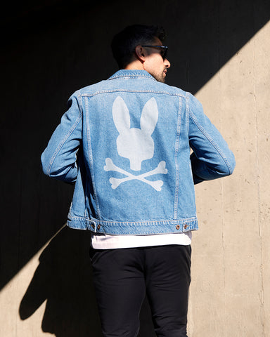 model wearing psycho bunny denim jacket with a bunny on the back