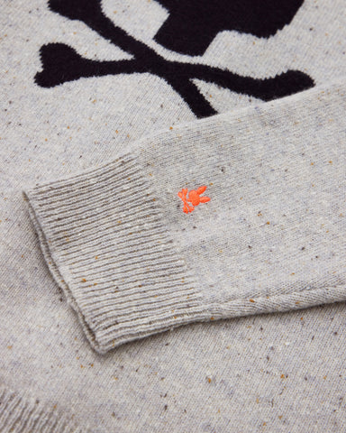 part of a sweater with psycho bunny's logo embroidered at the sleeve