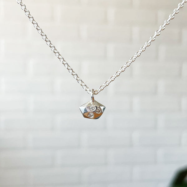 The silver Tiny Fragment necklace with two additional diamonds.