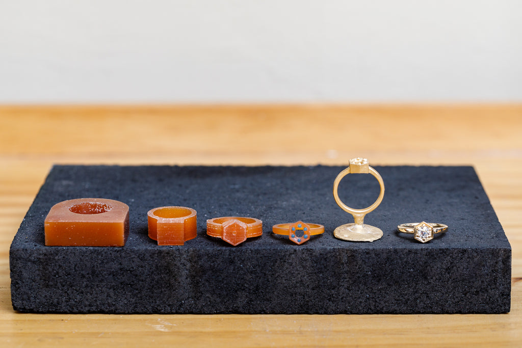 How It's Made (From Left to Right) Block of Wax, Progression of Carved waxes, Freshly Cast Gold Ring, Finished Ring with Diamond - Corey Egan