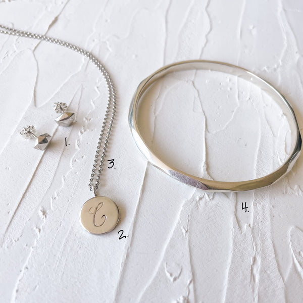 Cera's 7 Days of Jewelry Looks - Day 6: Thin silver denali bangle, a silver engraved initial necklace, and tiny fragment stud earrings
