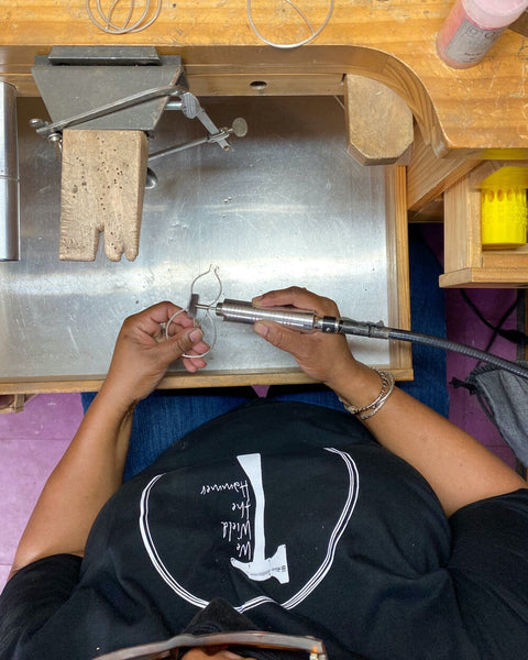 Karen Smith of We Wield the Hammer creating jewelry at her workbench