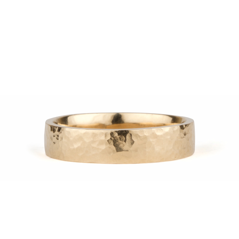 Flat hammered wedding band in yellow gold