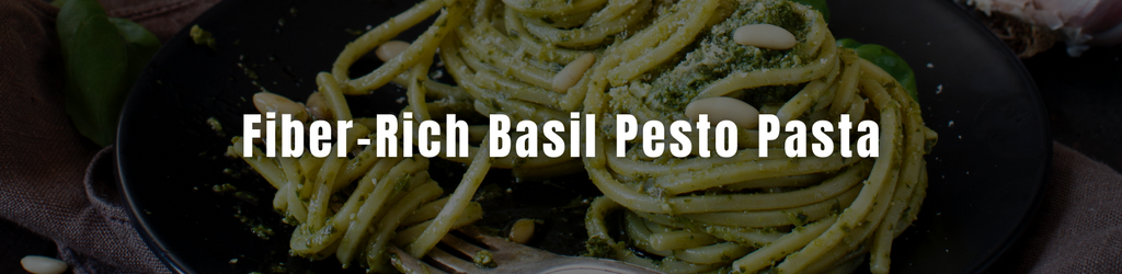 A plate of pesto pasta on a dark background with a text overlay that reads: Fiber-Rich Basil Pesto Pasta