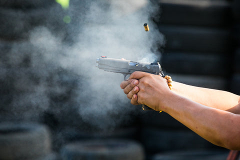Handgun being shot to demonstrate firearm stopping power