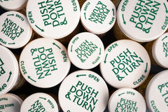 push and turn cannabis bottles