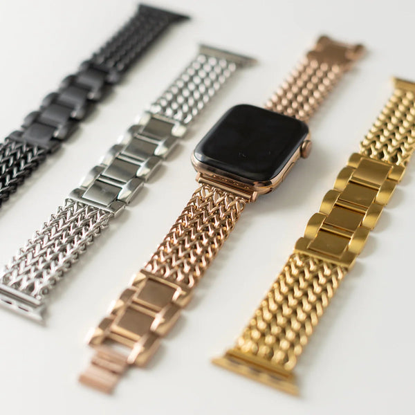 Gold Apple watch band on a white background