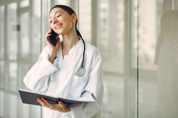 Female doctor talking on the phone and holding a folder - Hormonal Imbalance in Women