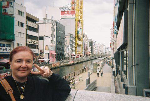 Mother and hair and make-up artist Isabella Schimid in Japan showing a peace sign