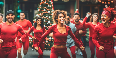 A group of people wearing red outfits dancing on the street enjoying each other’s company and their time together