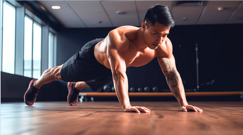 A bare-chested muscular man executing a plank on the floor showcasing balanced body alignment and engaging core muscles.