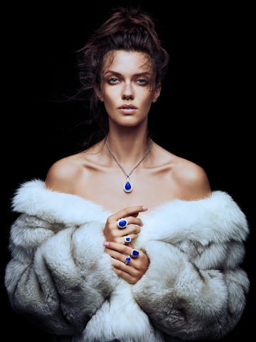 woman wearing white fur coat with tanzanite and diamond jewelry