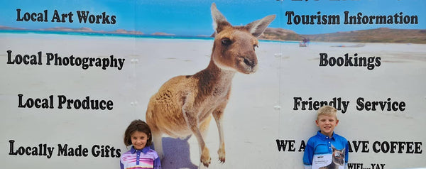 two kids on our anything and everything esperance shop side wall with kangaroo image behind them