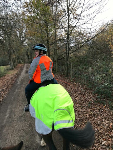 BTR Jacket in orange and reflective silver shown worn by a horse rider - great for visibility!