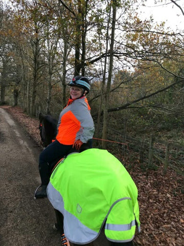 BTR Jacket in orange and reflective silver shown worn by a horse rider - great for visibility!