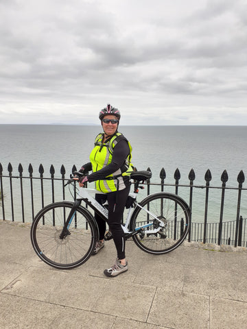 BTR high vis reflective gilet on a lady on a bicycle in Tenby seafront