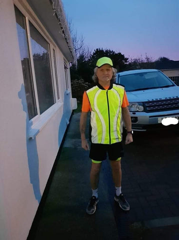 BTR high vis reflective running gilet worn by man in the evening