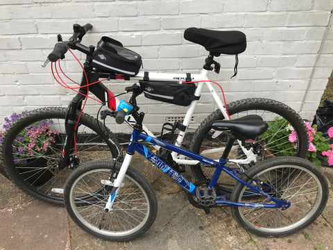 BTR bike phone bag and bike frame bag on adult bicycle along side child bicycle