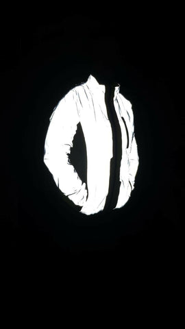 Be Totally Reflective jacket shown worn by a customer in the dark with flash 