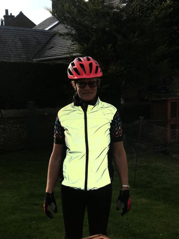 BTR reflective cycling gilet reflecting in the dark being worn by a woman