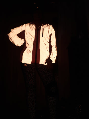 BTR high vis pink reflective cycling and running jacket reflecting in the dark worn by a woman