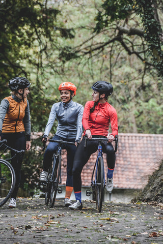 three women in cycling gear on an off road bike ride