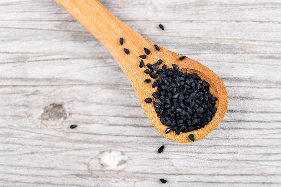 pure Black seed on a wooden spoon