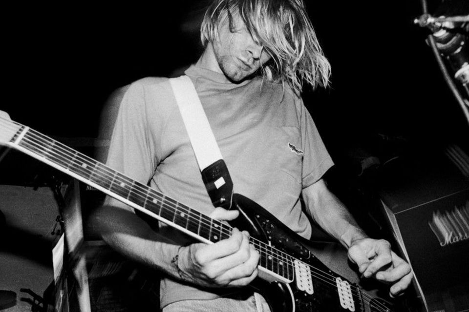 kurt cobain hair in face playing guitar