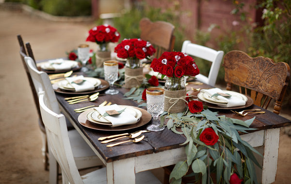 party with a rustic theme with red roses wood chairs